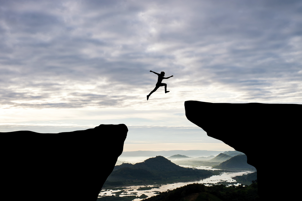 Person Jumping a Cliff