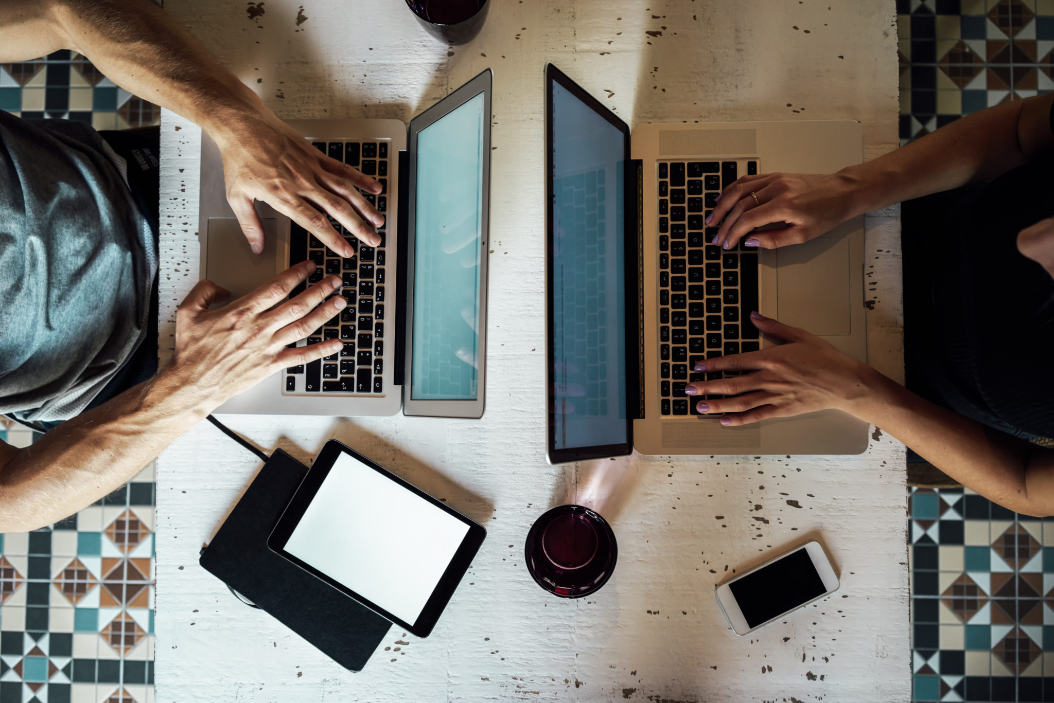 two bloggers working on laptops