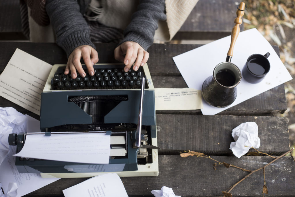 woman typing on typewriter