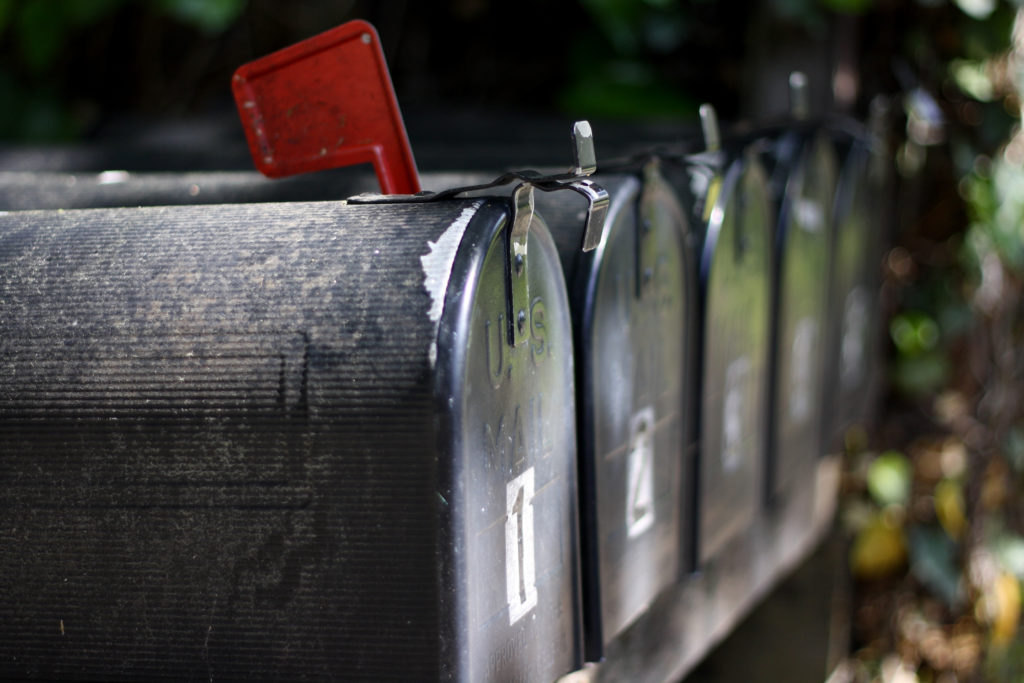 Mailbox with red flag up for mail collection. 