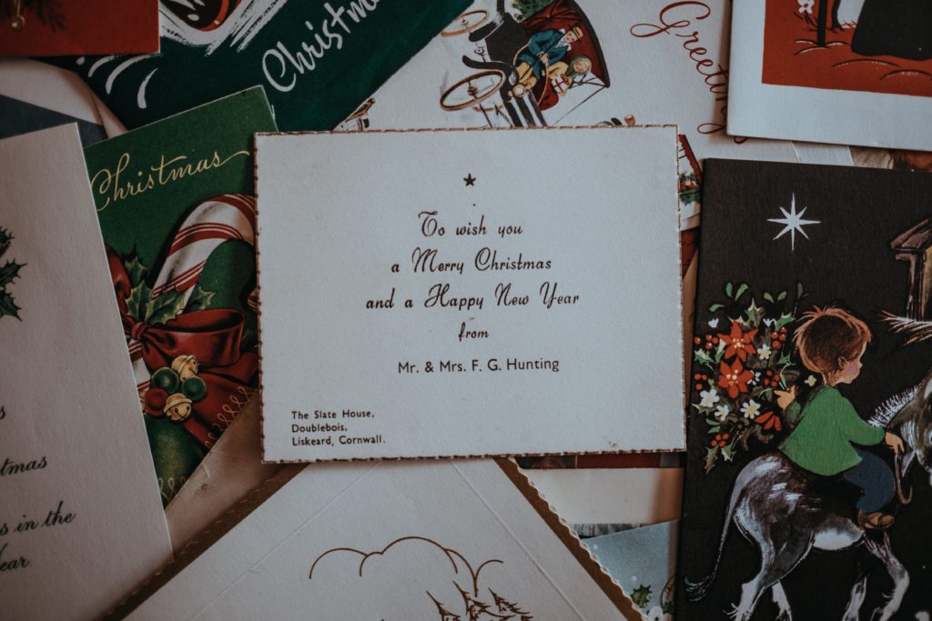 A message written inside a Christmas card surrounded by other Christmas cards. 